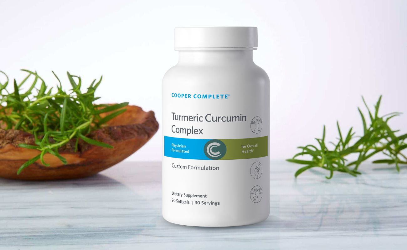 Bottle of Turmeric Curcumin Complex on counter with herb