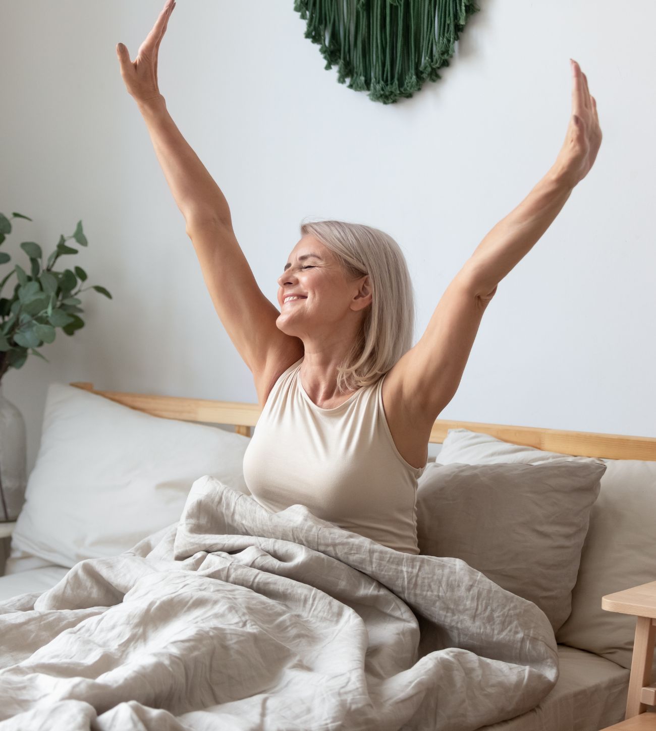 Photo of a mature woman awaking refreshed in the morning.