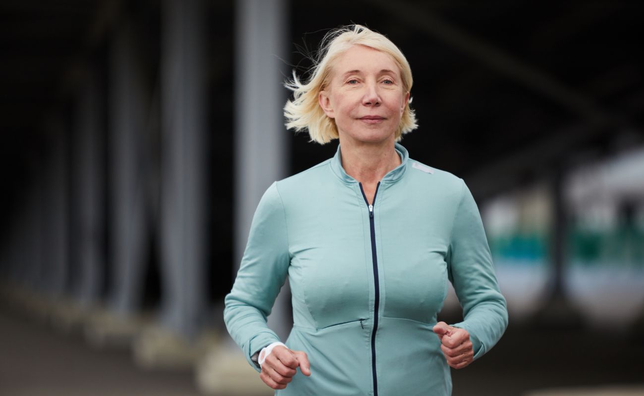 Photo of a woman running in an urban environment.