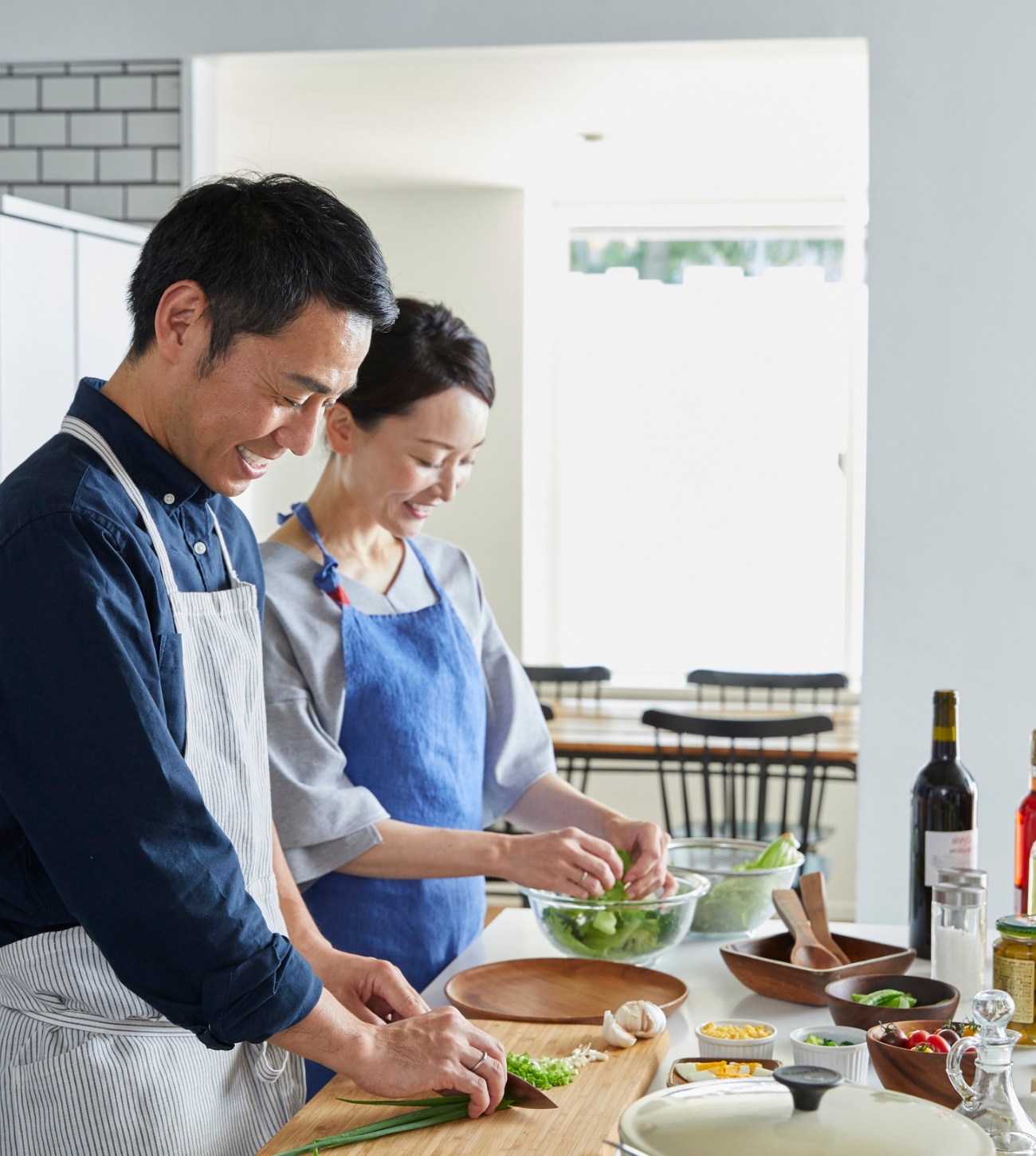 Mature couple prepping ingredients for dinner together.
