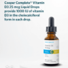 Bottle of Cooper Complete Vitamin D3 25mcg Liquid Drops on a pedestal with a description of the product