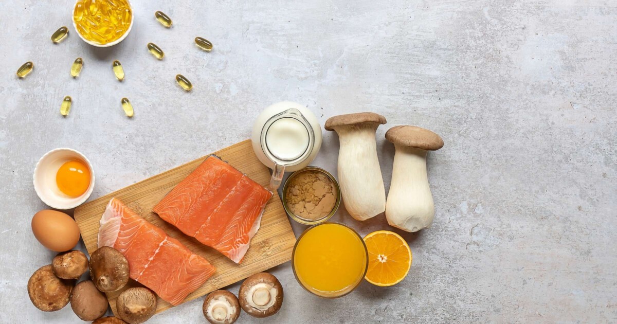 Image of vitamin D rich foods, including fortified orange juice, Salmon, mushrooms, egg yolks, and vitamin D3 softgels