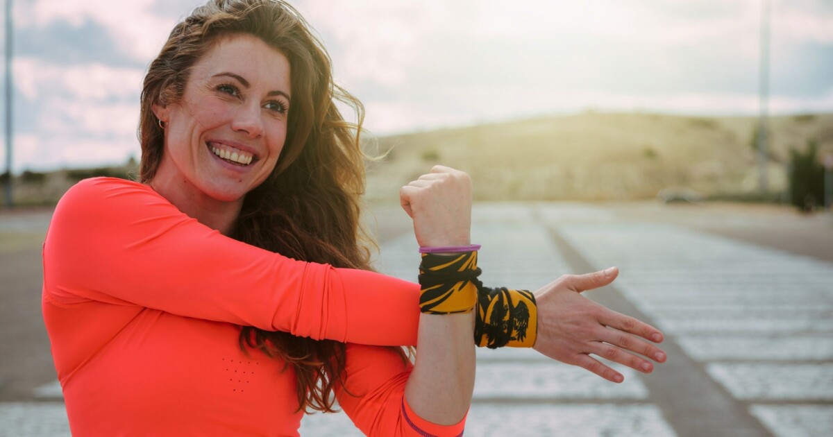 Woman stretching in preparation of her outdoor workout.